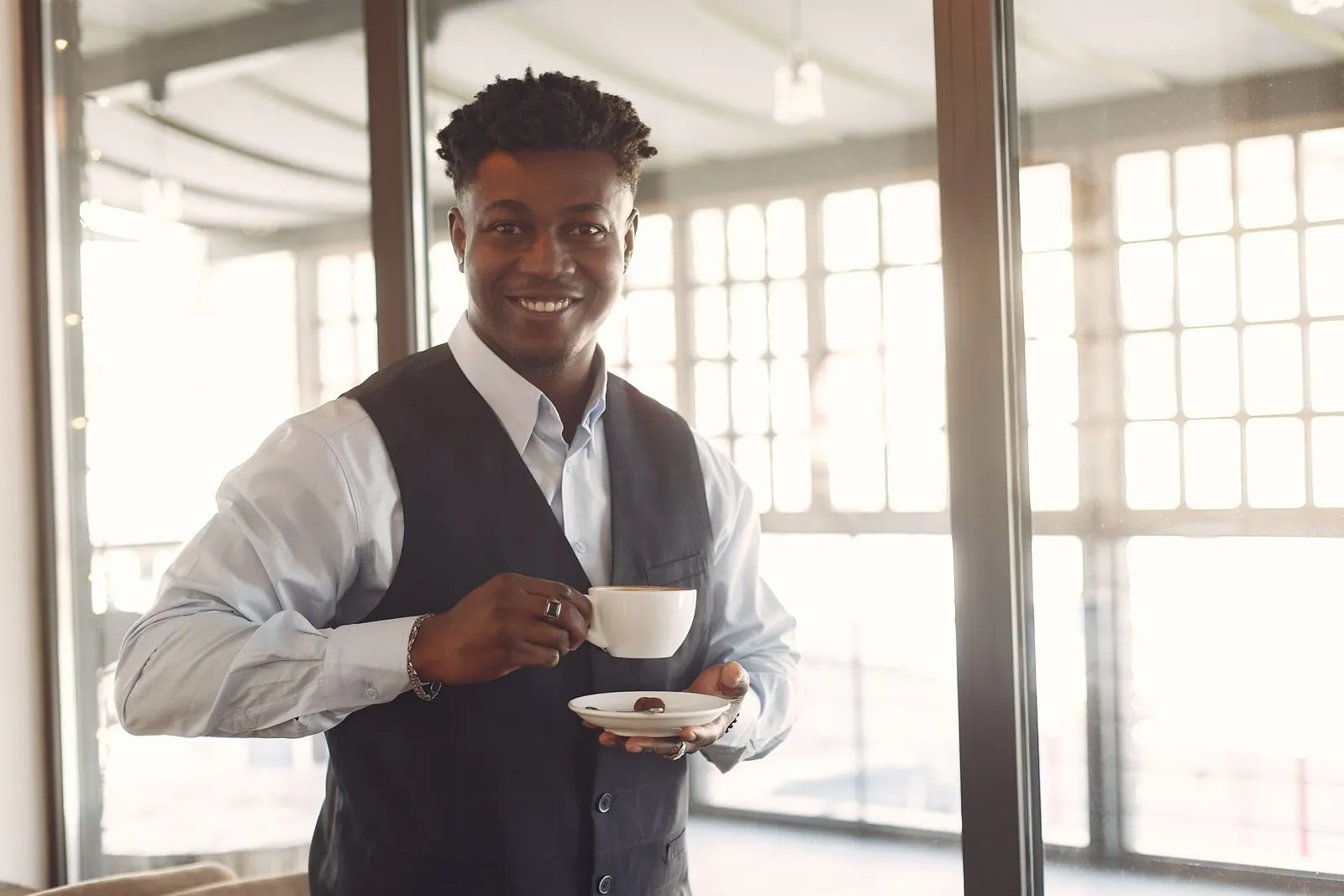 A restaurateur holding a coffee